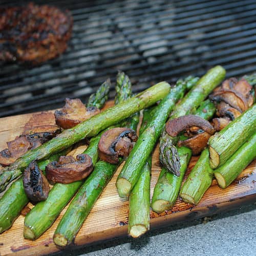 Vegetables including asparagus & mushroom on a grilling plank