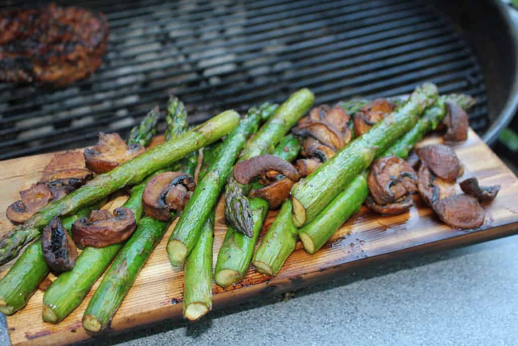 Vegetables including asparagus & mushroom on a grilling plank