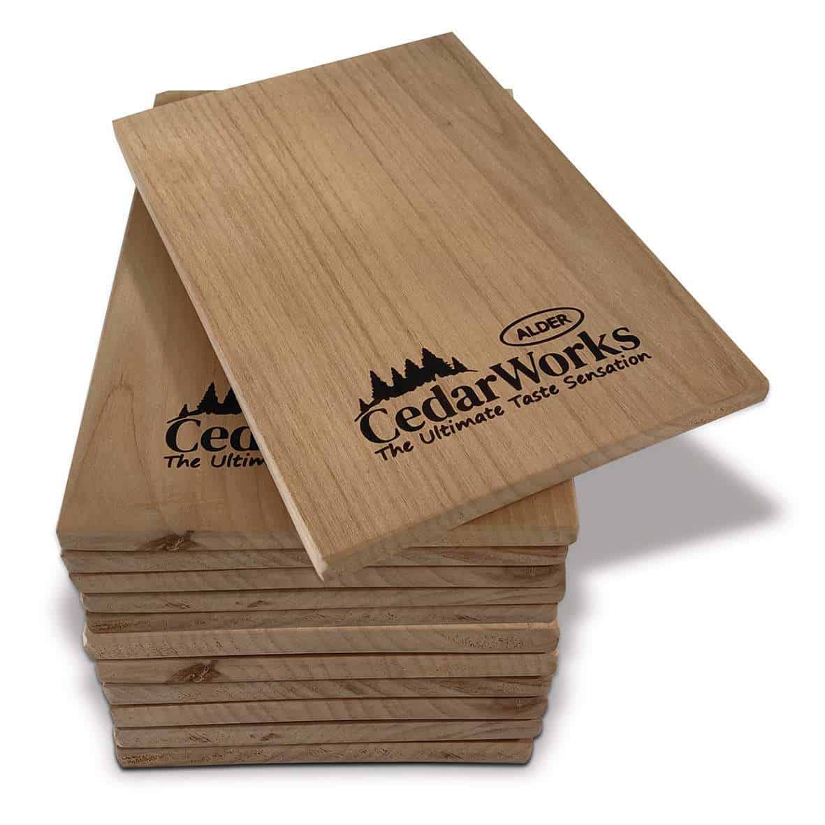 Smooth cedar wood tasting boards with Cedar Works and Alder branding, perfect for serving cheese and appetizers. Durable, stylish, and made from high-quality cedar wood. Ideal for gourmet food presentation.