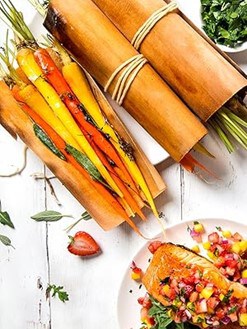 Colorful vegetable sticks wrapped in cedar leaf, ready for grilling or serving, showcasing sustainable, natural packaging.