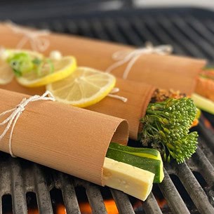 Picture12 Cedar Works reusable food wraps on grill with fresh lemon and herbs, eco-friendly alternative to plastic, sustainable kitchen products for food preservation.