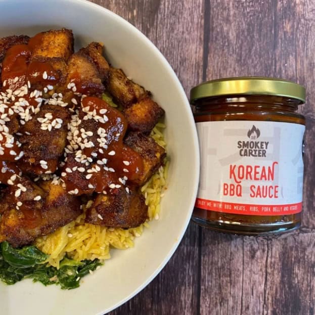 Crispy fried chicken with Korean BBQ sauce on rice, side of greens, Southern comfort food, smoky Carter Korean BBQ sauce, delicious Asian-inspired meal, authentic Korean flavors, food photography.