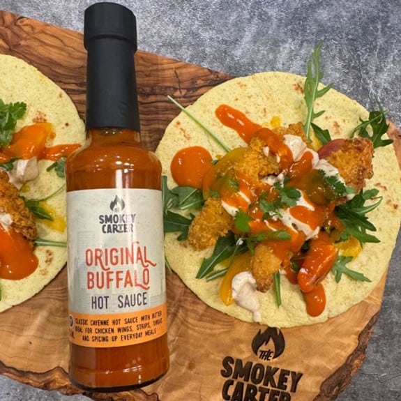 Smokey Carter BUFFALO HOT SAUCE_5 Creamy, flavorful Buffalo hot sauce by The Smokey Cartel, perfect for wings and snacks. Made with fresh ingredients, ideal for enhancing meals with authentic spicy taste.